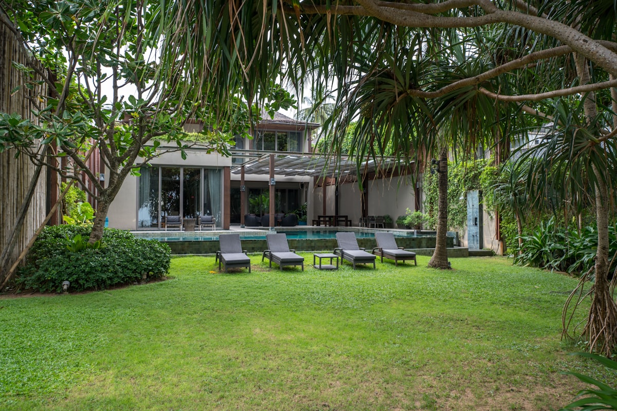 Poolside lounge chairs on synthetic grass — no muddy feet, no grass clippings in the water.