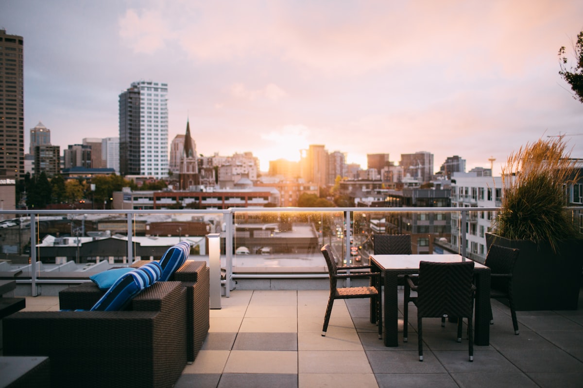 Rooftop turf with patio seating — lightweight underlayment protects the roof deck.