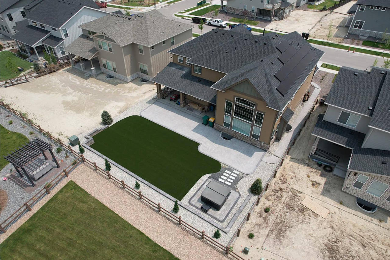 Aerial view of a backyard artificial turf lawn with a paver border — artificial turf in Centennial, CO