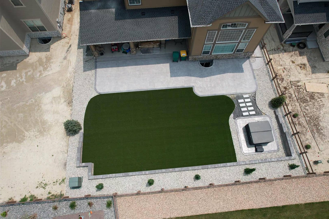 Top-down aerial of an artificial turf lawn and paver patio — artificial turf in Denver, CO