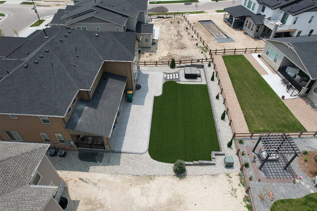 Aerial view of an artificial turf lawn with a paver patio and landscaping — artificial turf in Denver, CO