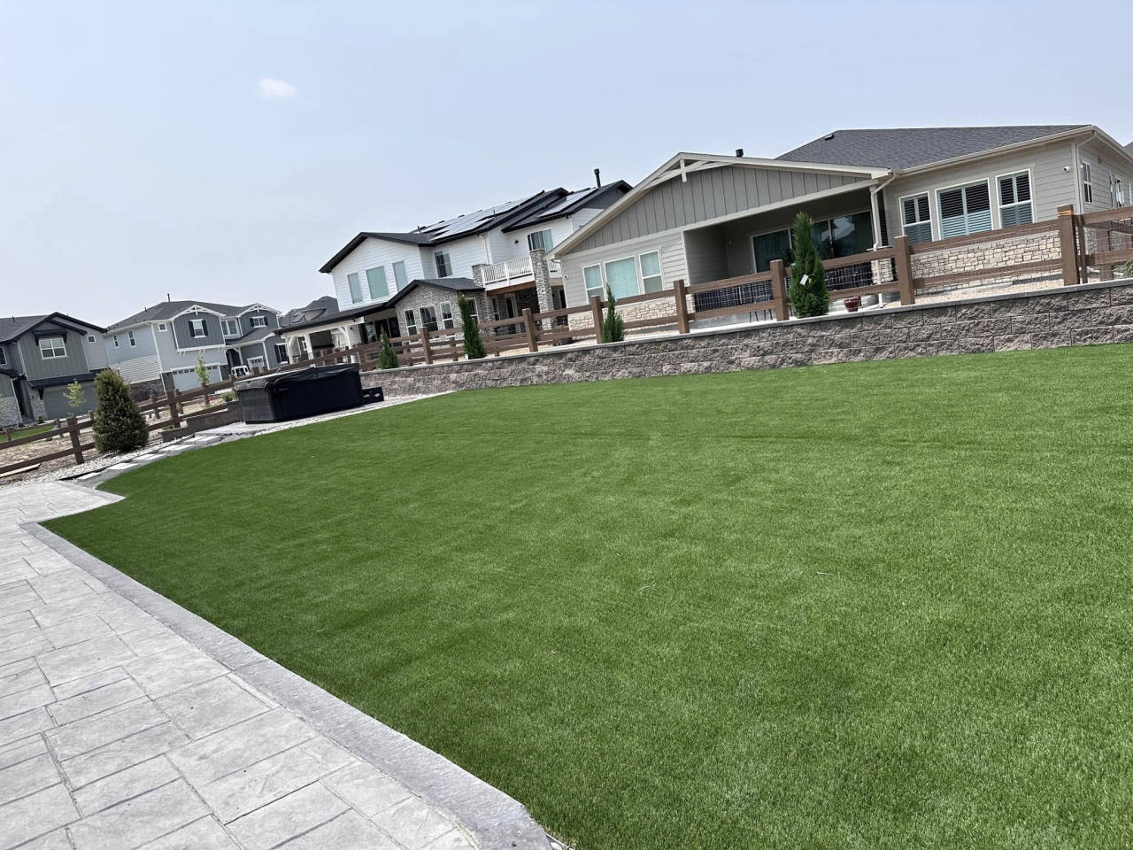 Artificial turf backyard with a stamped concrete border — artificial turf in Highlands Ranch, CO
